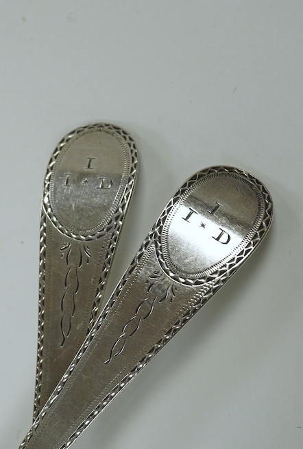 A pair of George III bright cut engraved Old English pattern table spoons, by John Lambe, London 1782, 21.1cm, together with two 19th century silver caddy spoons, a George III silver marrow scoop and a late Victorian sil